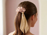 Sleek ponytail styled with Gala Blush Duet silk scrunchie