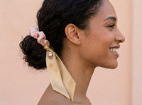 Low bun styled with Gala Blush Duet silk scrunchie