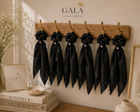 Gala Midnight Whisper black silk scrunchies displayed on brass hooks