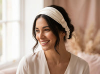 Woman smiling wearing ivory silk bandana