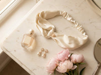 Ivory silk bandana flat lay on marble vanity