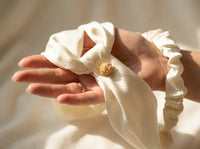 Detail of ivory silk bandana pearl cluster