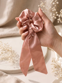 Rose Petal scrunchie held in hand
